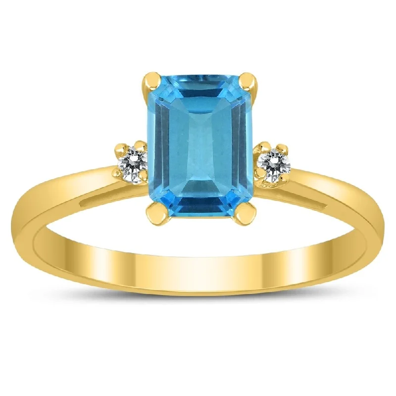 Emerald Cut 7X5MM Blue Topaz and Diamond Three Stone Ring in 10K Yellow Gold